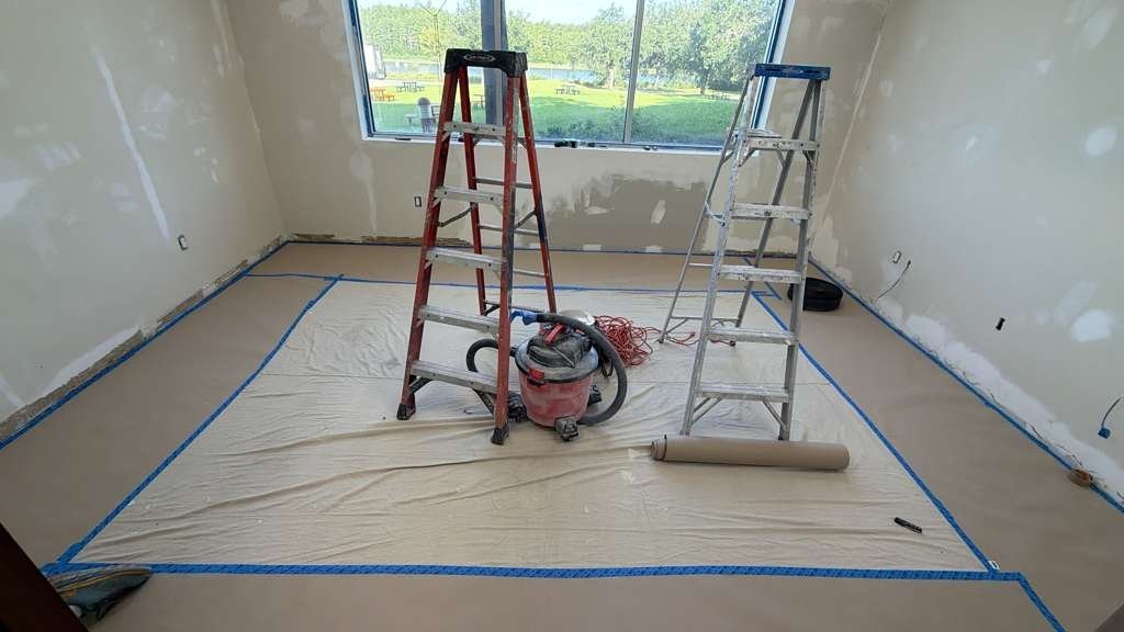 Floors fully covered and taped before painting