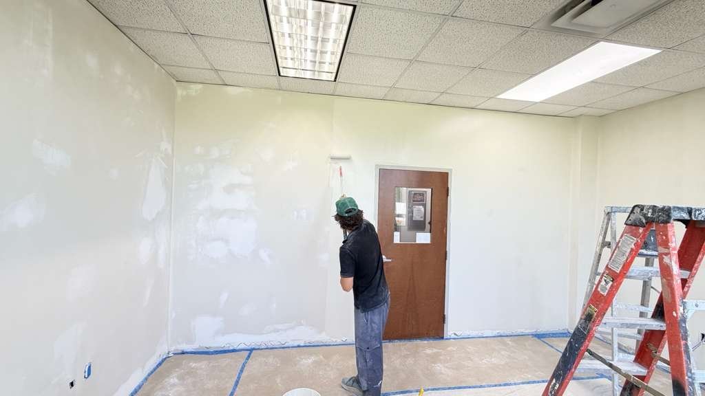 Professional painter rolling a smooth finish coat